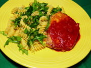 Skillet pork chops with sweet red pepper sauce with rotini and arugula.