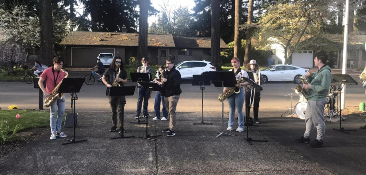 Members of the Washougal High School jazz ensemble perform in the driveway of Ray Johnson's Vancouver home on April 25.