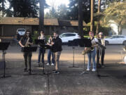 Members of the Washougal High School jazz ensemble perform in the driveway of Ray Johnson's Vancouver home on April 25.