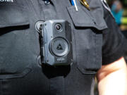 A Washougal police officer models one of the department's new body-worn cameras, which are affixed to the officer's uniform via a magnetic attachment and can record automatically in certain situations, such as when a firearm or Taser is drawn.