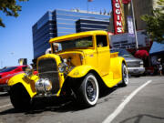 Pamela Lund peeks inside a 1931 Ford pickup during the Cruise the Couve event held on Main Street in Vancouver in 2019.