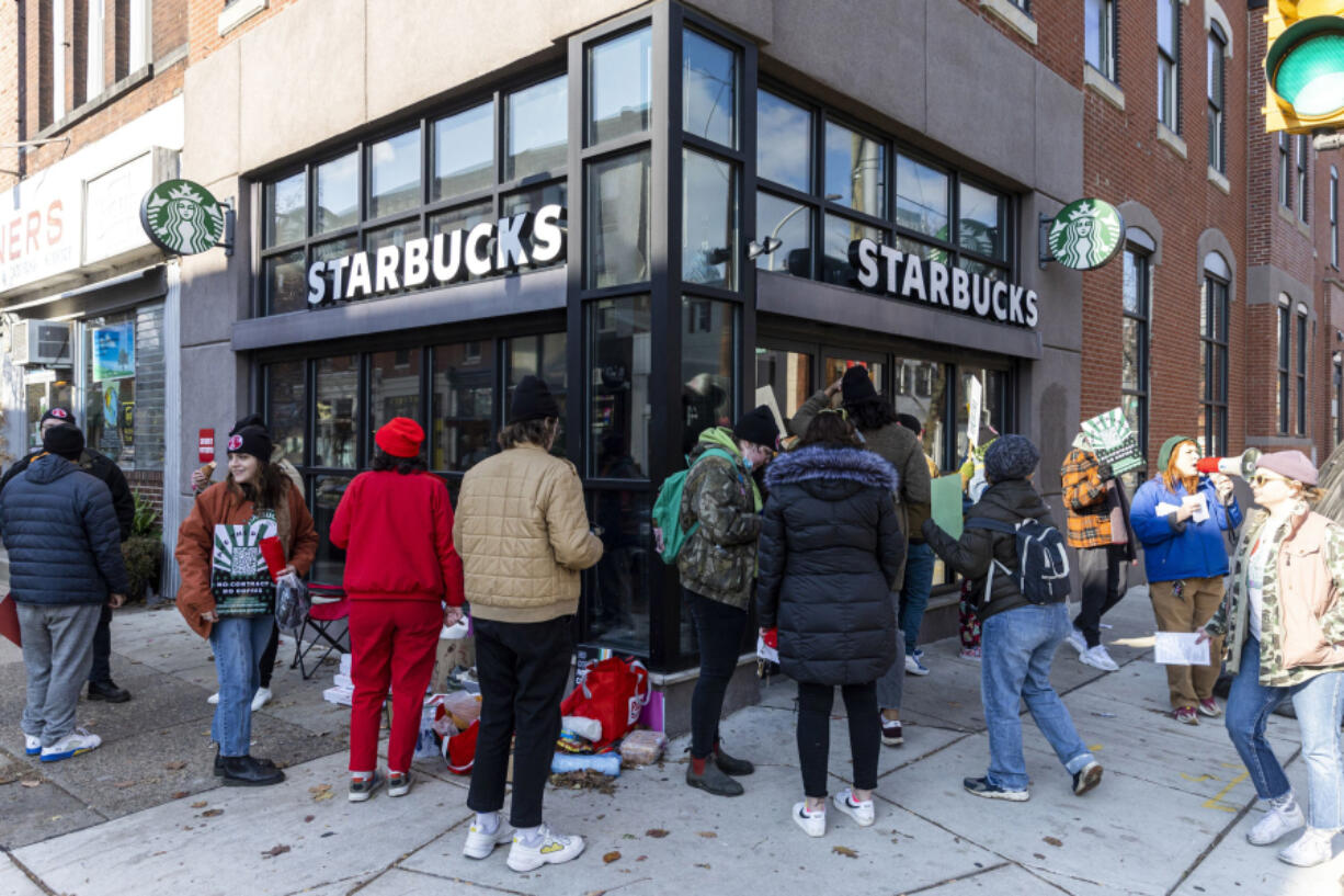 Starbucks workers organizing unions in recent years have complained of understaffing and other job-quality issues, which similarly arose in the Federal Reserve's recent focus groups with low-income and moderate-income workers. In this photo, Starbucks Workers Union members picket at a store on South Street and 22nd Street in Philadelphia on Nov. 17, 2022.