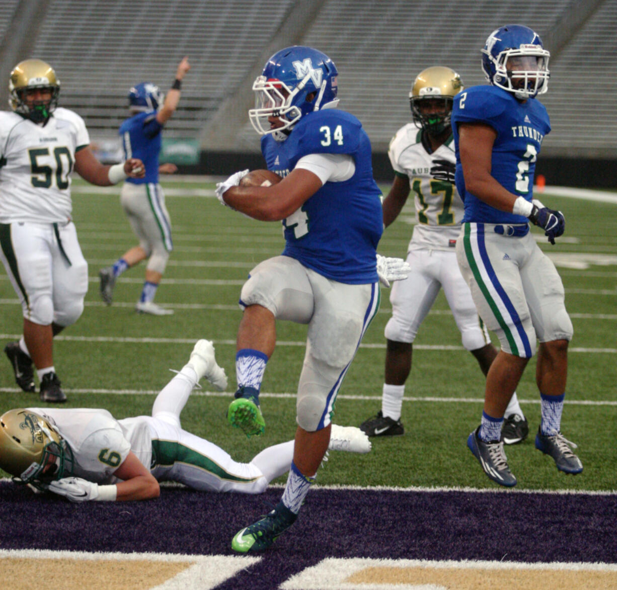 Mountain View running back Taj Albeck scores against Auburn in the 2015 Emerald City Kickoff Classic at Husky Stadium in Seattle. The state football championship games will be held at Husky Stadium at the end of the 2023 season.