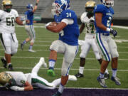 Mountain View running back Taj Albeck scores against Auburn in the 2015 Emerald City Kickoff Classic at Husky Stadium in Seattle. The state football championship games will be held at Husky Stadium at the end of the 2023 season.