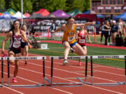 Kelso's Josie Settle clears the final hurdle on way to victory in the 3A girls 300-meter hurdles at the WIAA 2A/3A/4A State Track and Field Championships on Saturday, May 27, 2023, at Mount Tahoma High School in Tacoma.