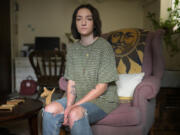 Lizzy Earhart sits in her apartment in Denver on Tuesday, May 30, 2023. Earhart says being treated for anorexia at an Eating Recovery Center facility left her with additional trauma.