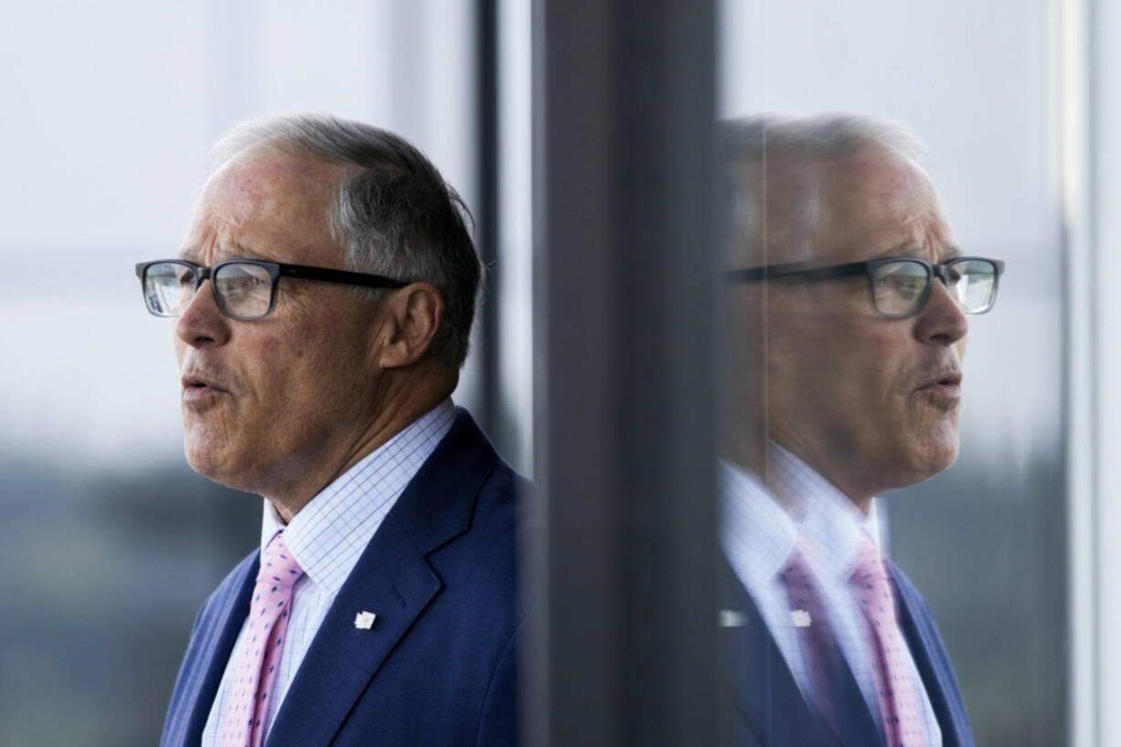 Washington Gov. Jay Inslee arrives at the University of Washington's Hans Rosling Center for Population Health ahead of signing several bills April 27 in Seattle.