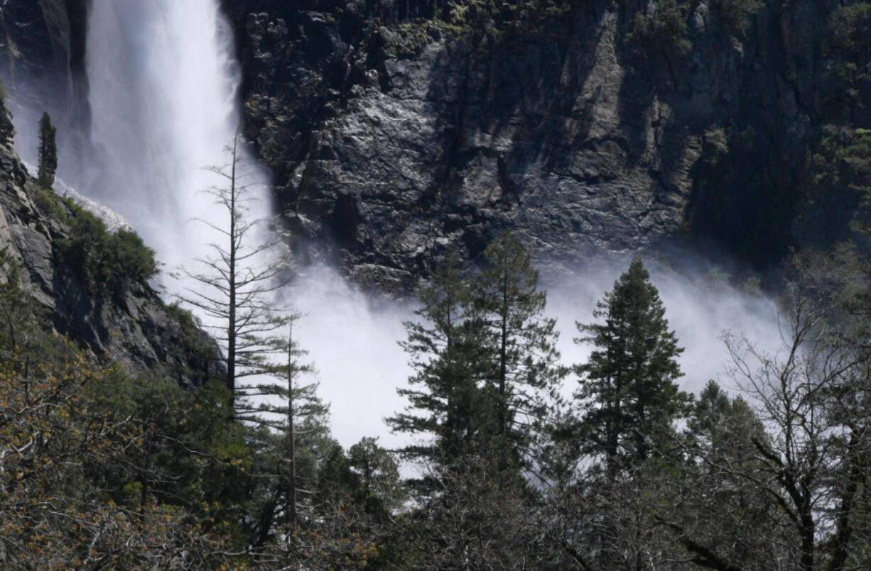 Bridalveil Fall's mist is seen through the trees April 28 in Yosemite Valley, Calif. Warmer weather is melting the snow which feeds the waterfalls and rivers.