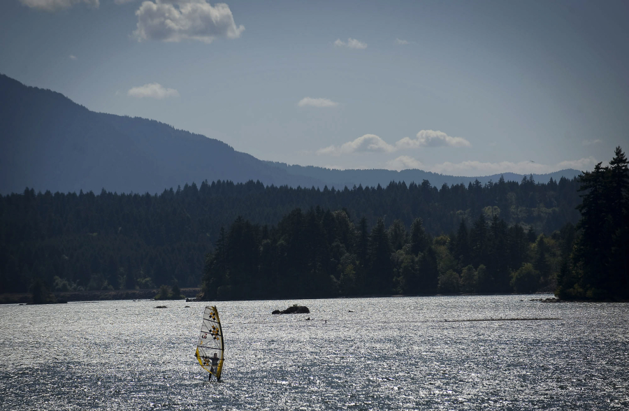 A windsurfer glides along the Columbia River near the Port of Skamania County in Stevenson on Monday August 15, 2011.