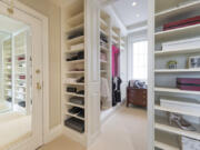 A large closet is converted into a closet and dressing area.