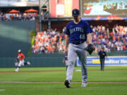 Seattle Mariners relief pitcher Justin Topa (48) heads to the clubhouse as Baltimore Orioles' Ryan McKenna, back left, runs the bases after hitting a two-run walkoff home run off him in the 10th inning of a baseball game, Saturday, June 24, 2023, in Baltimore. The Orioles won 6-4.