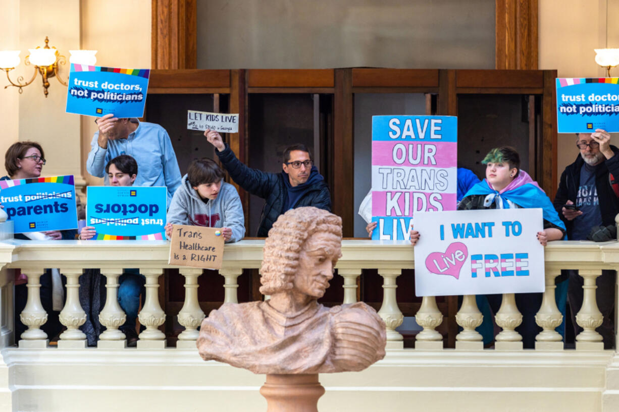 Opponents of SB 140, a bill that would prevent medical professionals from giving transgender children certain hormones or surgical treatment, gather in the Capitol in Atlanta on Monday, March 20, 2023.