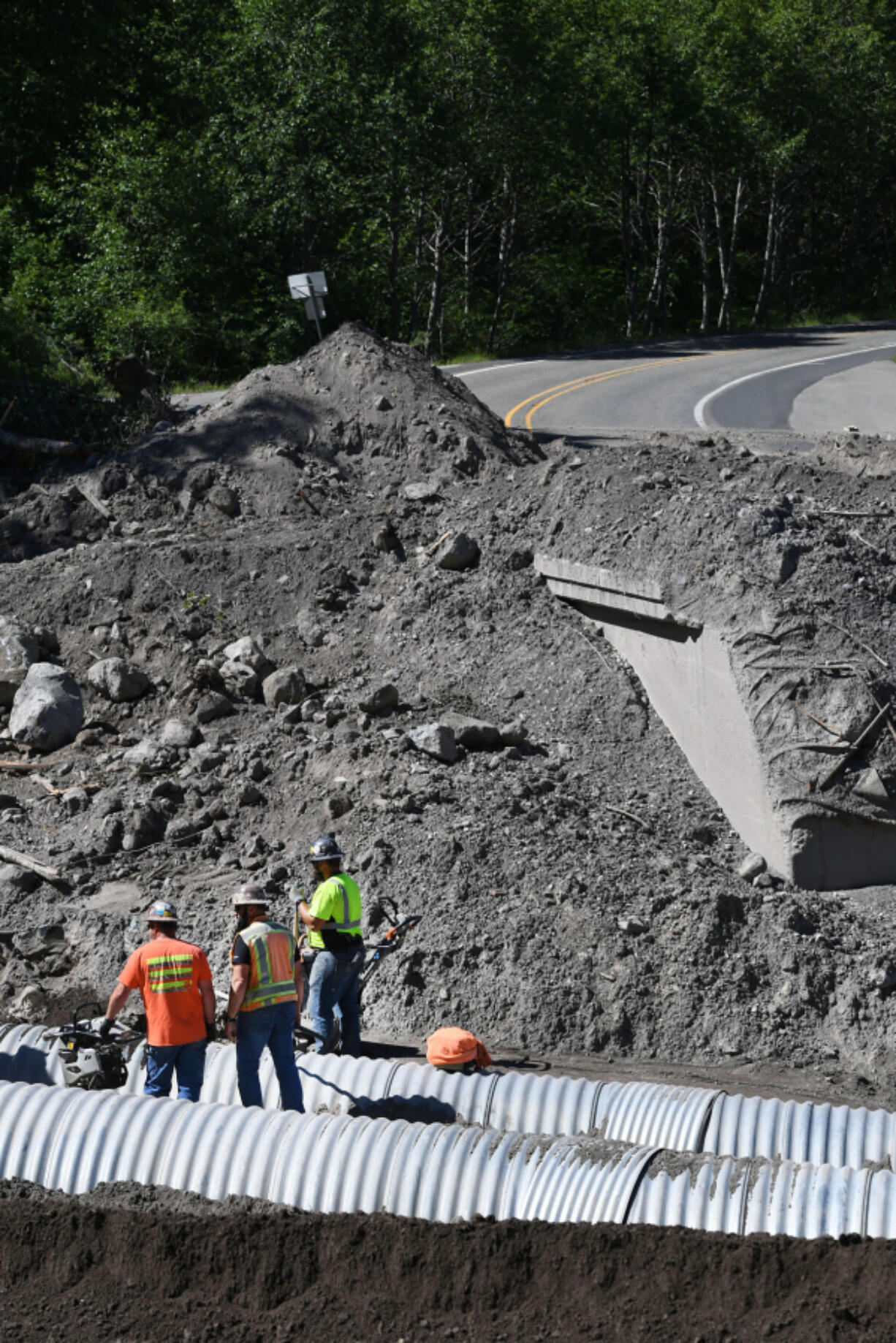 Scarsella Brothers, Inc. employees work to install culverts at the site of the South Coldwater Slide on Spirit Lake Memorial Highway on Thursday.