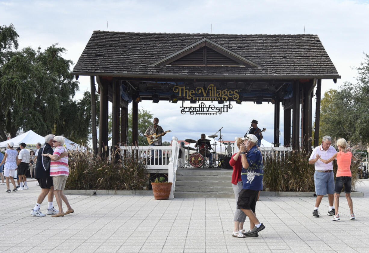 Residents dance in the square of The Villages retirement community Oct. 4, 2016, outside of Orlando, Fla.