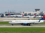 With the Atlanta skyline in the background, a Delta airplane lands at Hartsfield-Jackson Domestic Airport on Sept. 7, 2022, in Atlanta.