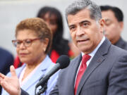 U.S. Health and Human Services Secretary Xavier Becerra speaks as Los Angeles Mayor Karen Bass looks on at a news conference following a tour and roundtable discussion at an Asian American Drug Abuse Program facility on May 31, 2023, in Los Angeles.