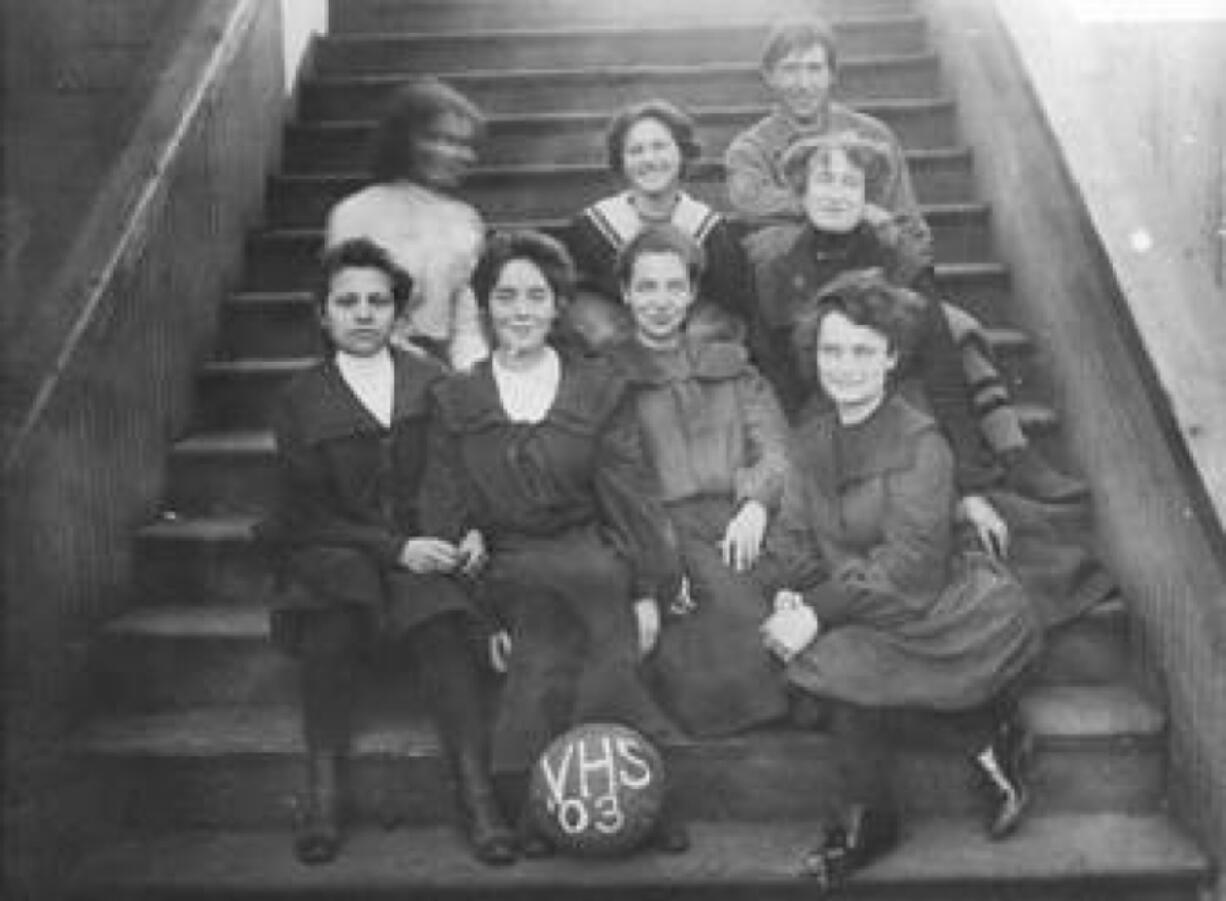 The Vancouver High School girls' basketball squad of 1903 wears the cumbersome uniforms of the day. The boys had more freedom of movement in their uniform of shorts and tank tops.