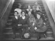 The Vancouver High School girls' basketball squad of 1903 wears the cumbersome uniforms of the day. The boys had more freedom of movement in their uniform of shorts and tank tops.