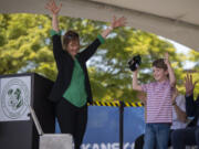 Center for Deaf and Hard of Hearing Youth interim executive director Shauna Bilyeu, left, applauds Washington School for the Deaf first-grader Dexter White, right, who brought a stuffed terrier mascot to put in a time capsule on Thursday during a groundbreaking ceremony for the Center for Deaf and Hard of Hearing Youth at Washington School for the Deaf. The capsule will be buried somewhere on campus and is set to be opened in 2104.