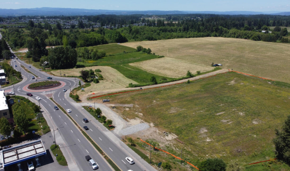 Orange construction barriers surround the future site of a Costco north of Pioneer Street on Friday in Ridgefield.