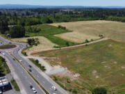 Orange construction barriers surround the future site of a Costco north of Pioneer Street on Friday in Ridgefield.