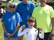 Ridgefield Lions, from left, Roxanne Cortez, Dean Stenehjem and John Schroeder assist blind athlete Lincoln Bradshaw with the modified shot put.