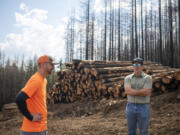 American Forests Pacific Northwest Director Brian Morris, right, and AKS Forestry and Engineering arborist Bryce Hanson talk about the fire recovery efforts June 23 at the Nakia Creek Fire site northeast of Camas.