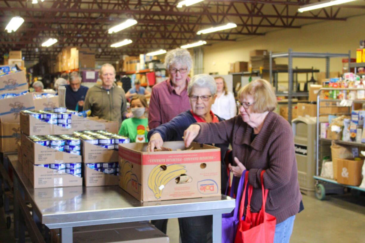 On the last day of the Backpack Program until fall, volunteers worked in an efficient assembly line to stuff tote bags full of nonperishable food. The bags would then be loaded into cars and delivered to 85 schools across the county.