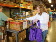 Volunteers of Share's Backpack Program, which provides bags of food to families across the county, filled totes of canned goods, oatmeal and snacks.