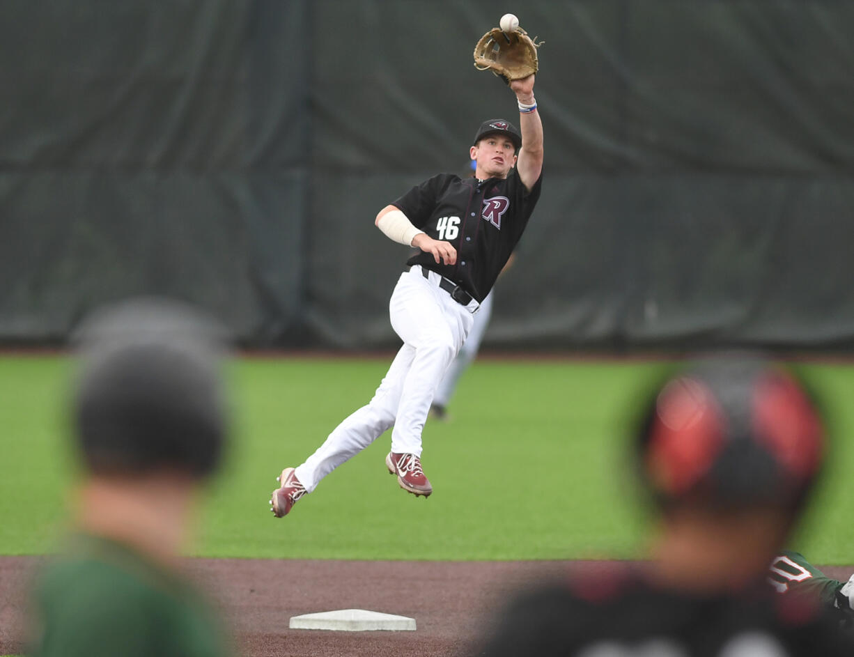 Raptors infielder Jackson Nicklaus makes a leaping catch at second base to try and get an out Friday, June 16, 2023, during the Raptors’ game against Cowlitz at the Ridgefield Outdoor Recreation Complex.