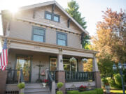 The sun peeks over the roof of Vancouver's historic John P. and Mary Kiggins House in Vancouver.