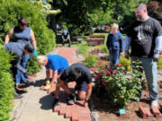 Members and family of the Lewis River Rotary Club recently gathered to install a brick walkway in Battle Ground's Central Park.