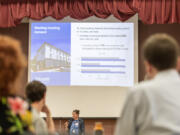 A crowd listens to a presentation from City of Vancouver Housing Programs Manager Samantha Whitley Monday during a community forum at Eleanor Roosevelt Elementary School.
