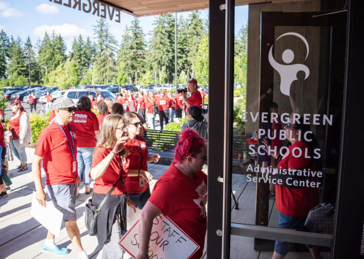 Evergreen Education Association members and allies walk into the Evergreen Public Schools headquarters on June 14 in advance of a school board meeting. The union held the rally before the meeting to draw attention to priorities in this year's ongoing bargaining session and relay messages of feeling unheard by district leaders.