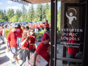 Evergreen Education Association members and allies walk into the Evergreen Public Schools headquarters on June 14 in advance of a school board meeting. The union held the rally before the meeting to draw attention to priorities in this year's ongoing bargaining session and relay messages of feeling unheard by district leaders.