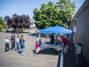 Taylor Balkom/The Columbian 
 Columbian employees enjoy a hot-dog barbecue at the newspaper office on Thursday.