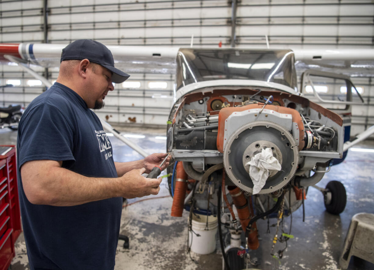 Director of maintenance Jason Cochran works on the front of an airplane at Pearson Field. Clark County's regional airports directly contribute millions of dollars in business revenues to the local economy, according to a study from the Washington State Department of Transportation.