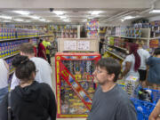 Customers shop for fireworks Wednesday at BlackJack Fireworks in Hazel Dell.