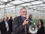 Benno Dobbe leads a crowd on a tour of one of his greenhouses at Holland America Flower Gardens in Woodland. Dobbe has donated money to fund a splashpad in Woodland.