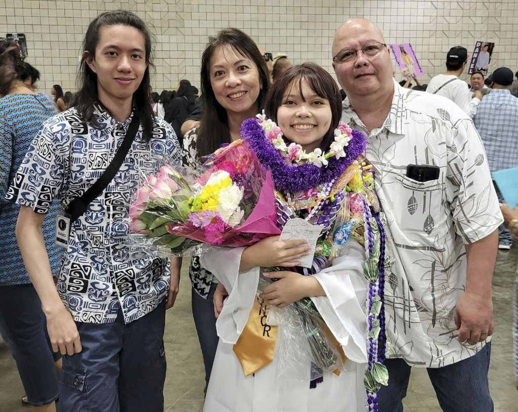 In this photo provided by Vernon Tyau, Jarek Agcaoili, left, with his mother Danielle, sister Jessika and father Maury Agcaoili pose in May 2023, at Jessika's high school graduation in Hawaii. Danielle and Maury Agcaoili were among boaters who died Sunday, May 28, 2023, near Sitka, Alaska, when a fishing vessel ran into trouble in rough seas.
