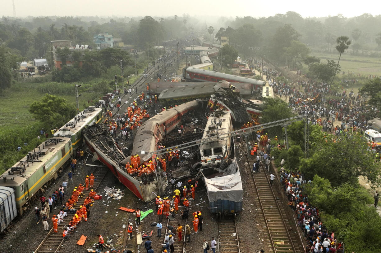 A drone shot of rescuers work at the site of passenger trains accident, in Balasore district, in the eastern Indian state of Orissa, Saturday, June 3, 2023. Rescuers are wading through piles of debris and wreckage to pull out bodies and free people after two passenger trains derailed in India, killing more than 280 people. Hundreds of others were trapped inside more than a dozen mangled rail cars, in one of the country's deadliest train crashes in decades.