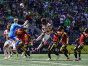 Seattle Sounders goalkeeper Stefan Frei, left, goes up to defend against Portland Timbers forward Dairon Asprilla (27) during a free kick during the first half of an MLS soccer match, Saturday, June 3, 2023, in Seattle.