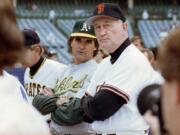 American League manager Tony La Russa, center left, from the Oakland A's, and National League manager Roger Craig, of the San Francisco Giants, watch batting practice at Wrigley Field in Chicago, July 10, 1990, before the start of the 61st All-Star Game. Craig, who pitched for three championship teams during his major league career and then managed the San Francisco Giants to the 1989 World Series that was interrupted by a massive earthquake, died Sunday, June 4, 2023. He was 93.