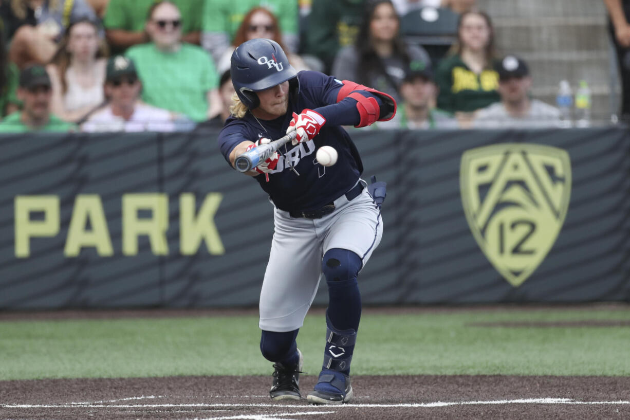 Oral Roberts utility Jonah Cox (7) bunts against Oregon during an NCAA college baseball tournament super regional game Friday, June 9, 2023, in Eugene, Ore. Oregon won 9-8.