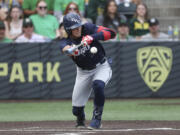 Oral Roberts utility Jonah Cox (7) bunts against Oregon during an NCAA college baseball tournament super regional game Friday, June 9, 2023, in Eugene, Ore. Oregon won 9-8.