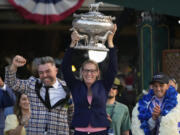 Trainer Jena Antonucci, center, hoists up the August Belmont Trophy alongside jockey Javier Castellano, right, and owner Jon Ebbert, left, after their horse Arcangelo won the 155th running of the Belmont Stakes horse race, Saturday, June 10, 2023, at Belmont Park in Elmont, N.Y.