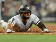 Chicago White Sox's Elvis Andrus slides home to score off a single by Zach Remillard during the ninth inning of a baseball game against the Seattle Mariners, Saturday, June 17, 2023, in Seattle.