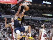 Denver Nuggets forward Aaron Gordon (50)dunks the ball during the first half of Game 4 of the basketball NBA Finals against the Miami Heat, Friday, June 9, 2023, in Miami.