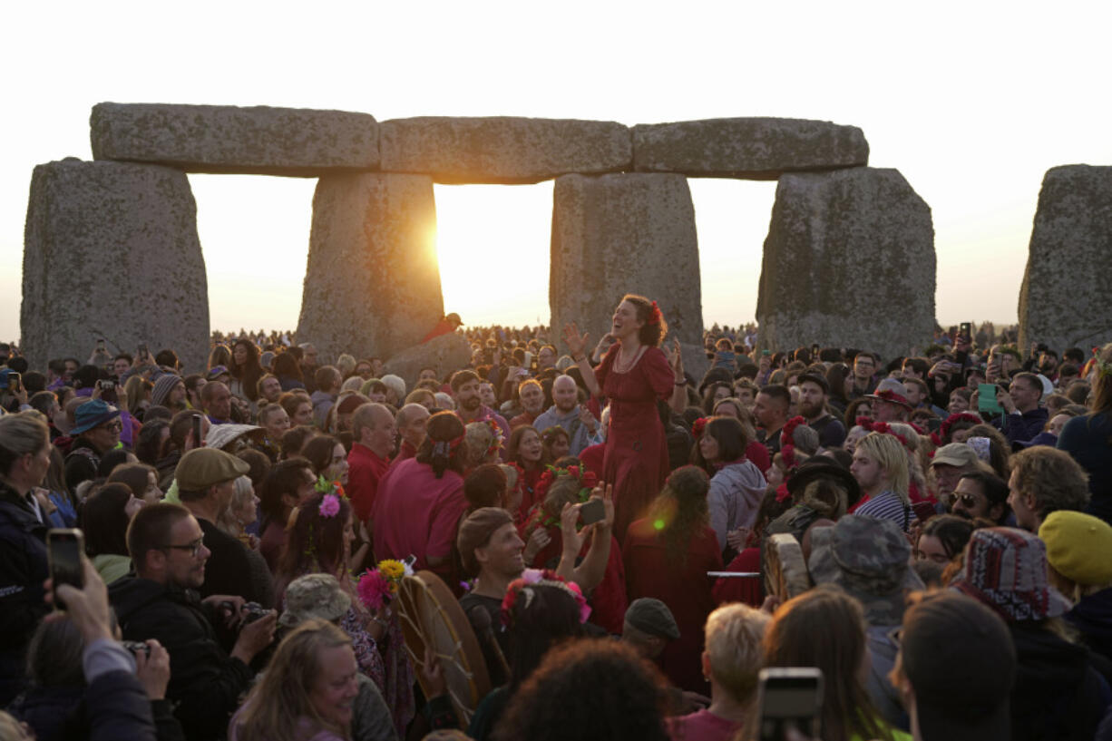 Revelers gather at the ancient stone circle Stonehenge to celebrate the Summer Solstice, the longest day of the year, near Salisbury, England, Wednesday, June 21, 2023. Druids, pagans, hippies, local residents, tourists and costumed witches and wizards have gathered around a prehistoric stone circle on a plain in southern England to express their devotion to the sun.