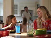 OB-GYN Dr. Kylie Cooper sits at the dinner table with her daughter, Hazel, Thursday, June 15, 2023, in Minnesota. The family is settling into the new house after moving. They're figuring out new schedules and looking for new friends.